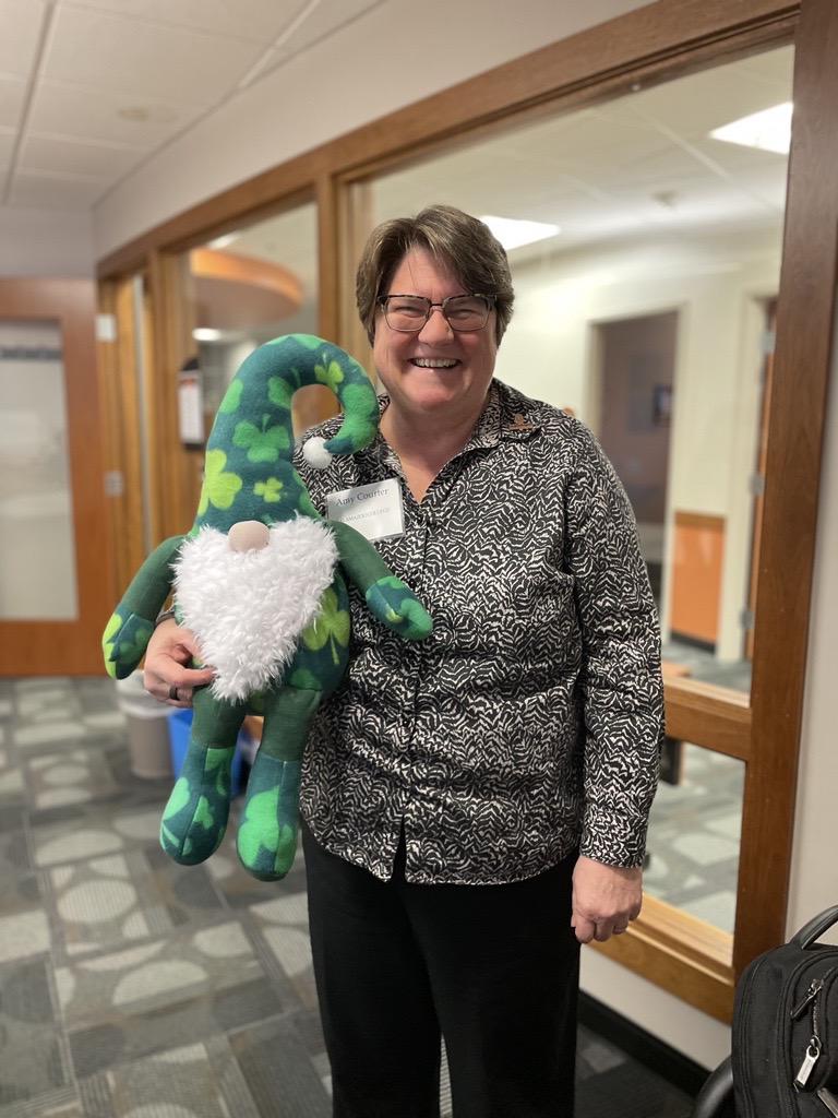 Image of Amy Courter, Chair for the Risk Review Committee, holding Jerome the Leprechaun Gnome!