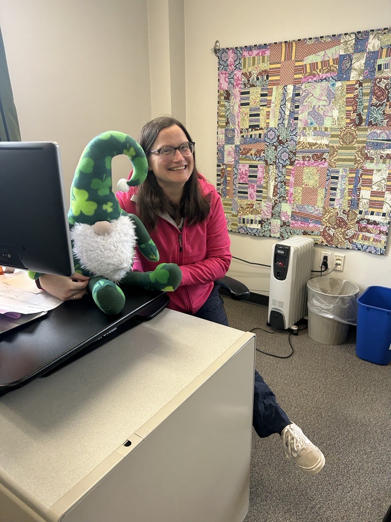 Director of Grants, Fellowship and Research, Jessica Fowle holding Jerome the leprechaun gnome