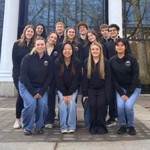 group photo of student government in front of hicks student center